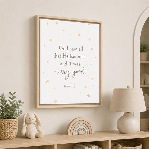 A framed wall art print with a Bible verse and small gold stars, displayed in a styled nursery setting above a wooden shelf with a lamp, bunny toy, and plant.