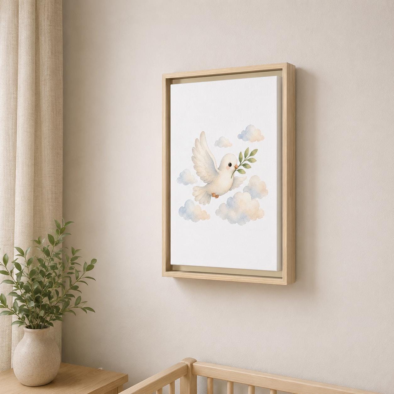 A framed wall art print hangs on a beige wall above a wooden crib, showing a white dove carrying an olive branch among soft pastel clouds. The frame is light wood, and a small potted plant and curtain are visible in the room.