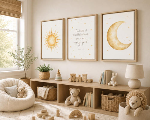 Three framed nursery wall art prints hang above a wooden storage shelf in a styled children's room. The prints feature a yellow sun, a scripture quote, and a gold crescent moon with small stars.