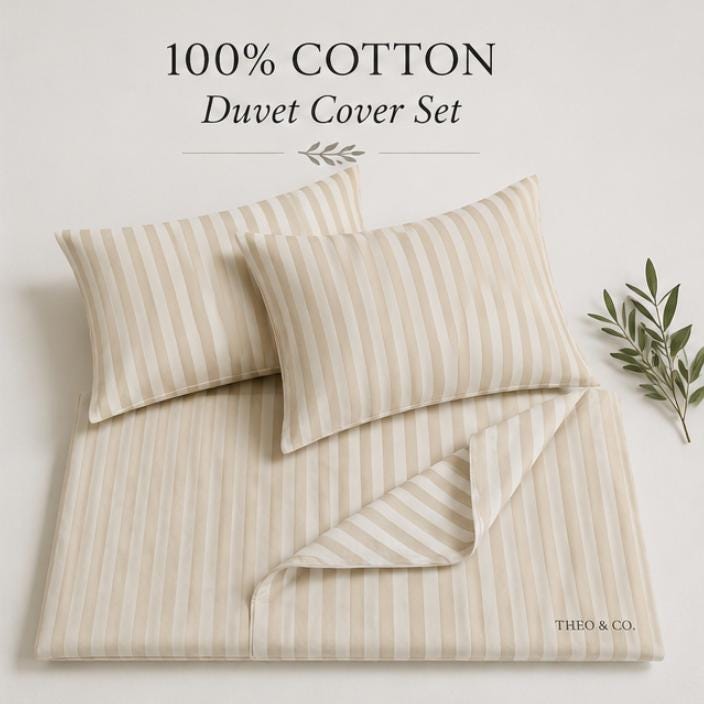 A 100% cotton duvet cover set in a cream and light beige vertical stripe pattern, featuring two pillows and a folded duvet cover, styled with a small green leaf branch on a light beige background. Text at the top reads '100% COTTON Duvet Cover Set' and the brand 'THEO.