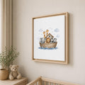 A framed nursery art print featuring Noah's Ark with cartoon animals, hanging on a beige wall above a wooden crib next to a teddy bear and a potted plant.