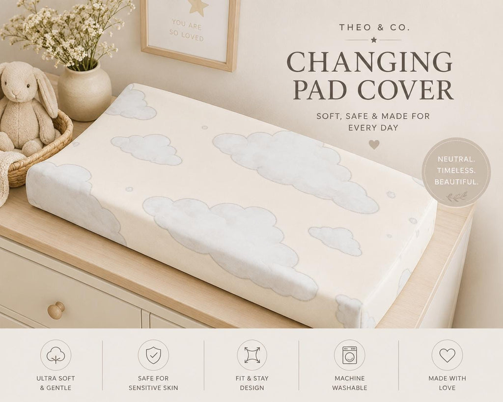 A fitted changing pad cover with a soft cloud pattern in light blue and gray on an off-white background, shown on a wooden changing table in a styled nursery setting. The image includes text overlays reading 'THEO & CO.