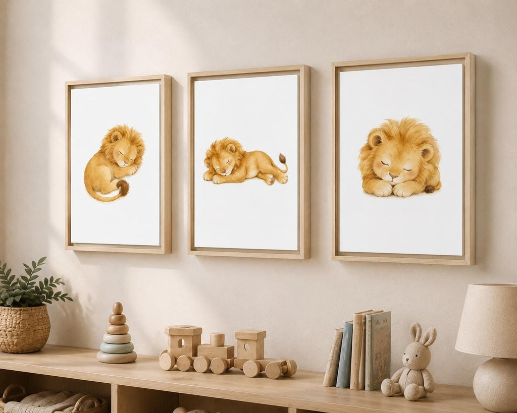 Three framed watercolor lion prints hang on a beige wall above a wooden shelf with toys, books, and a lamp in a styled nursery setting.