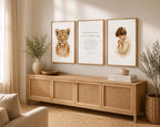 Three framed wall art prints displayed above a light wood console in a warm, styled room. The left print shows a lion cub, the center print features inspirational text, and the right print depicts a child with a book.