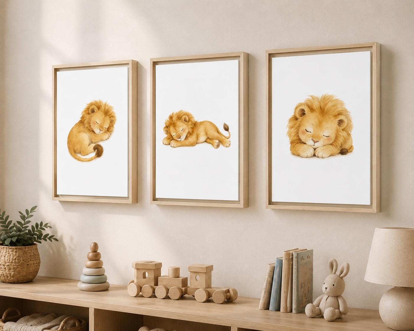 Three framed watercolor lion prints hang on a beige wall above a wooden shelf with toys, books, and a lamp in a styled nursery setting.