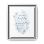 A framed typographic wall art print with a watercolor splash in soft blue and beige tones on a white background. The text reads, 'YOU ARE fearfully and wonderfully MADE.