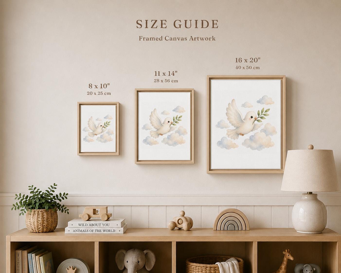 A size guide poster for framed canvas wall art, showing three framed prints of a white dove in the clouds with dimensions labeled 8 x 10", 11 x 14", and 16 x 20". The poster is displayed on a beige wall above a wooden shelf with nursery decor.