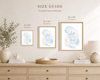 A size guide mockup for three framed canvas art prints hanging above a light wood console table. The prints feature a soft blue watercolor background with elegant script text, each in a different size: 8 x 10 inches, 11 x 14 inches, and 16 x 20 inches.