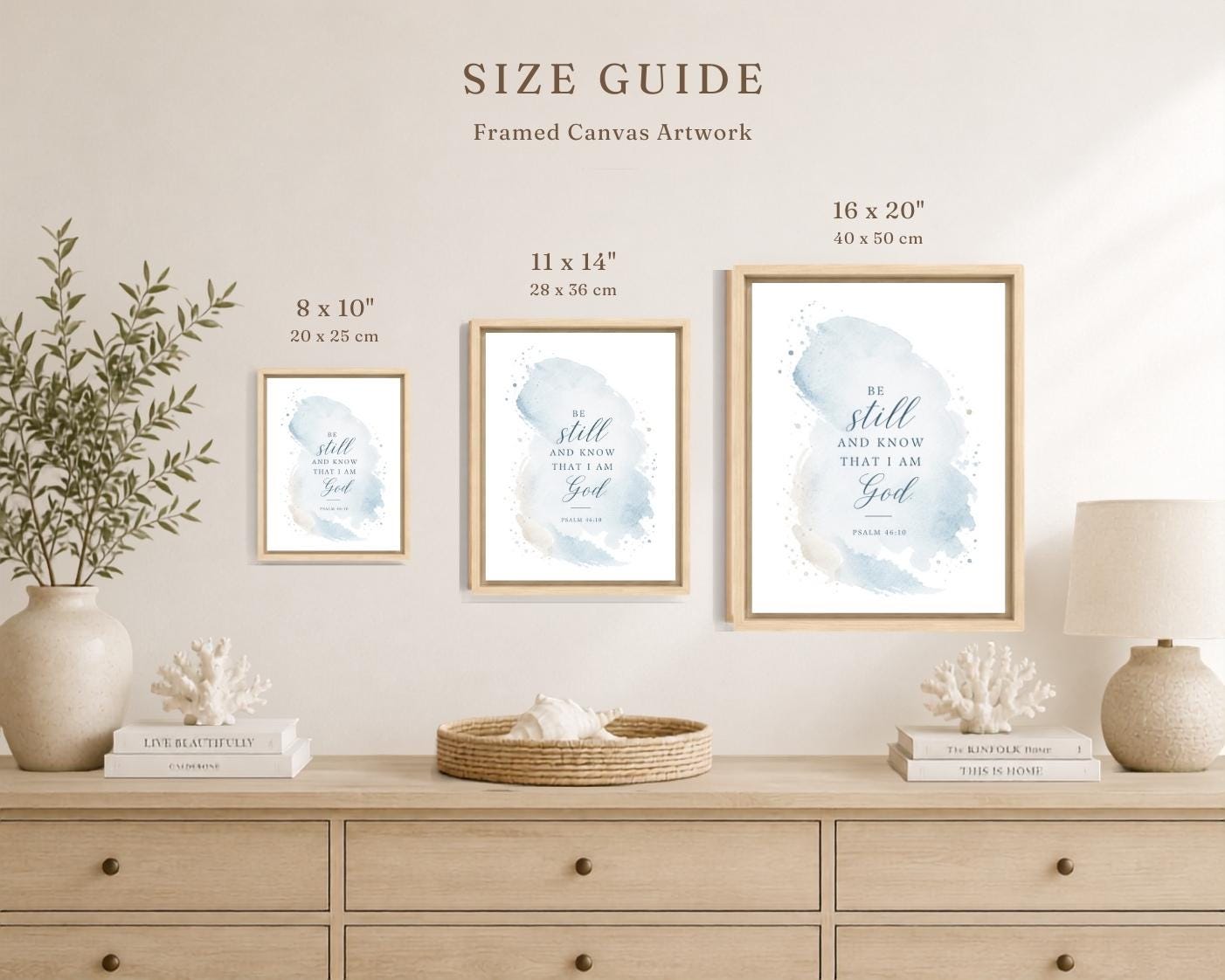 A size guide mockup for three framed canvas art prints hanging above a light wood console table. The prints feature a soft blue watercolor background with elegant script text, each in a different size: 8 x 10 inches, 11 x 14 inches, and 16 x 20 inches.