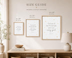 A size guide mockup showing three framed canvas art prints hanging on a beige wall above a wooden console table. The prints display scripture quotes in black script with small gold stars on a white background, in light wood frames.