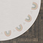Close-up of pink and clear beaded strands on a dark surface with a white circular design in the background.