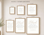 A size comparison chart showing six framed Bible print options with dimensions labeled: 8"x10", 11"x14", 16"x20", 18"x24", 24"x36", and 32"x48". The prints feature elegant gold and black typography on a white background, displayed in light wood frames against a warm beige wall.