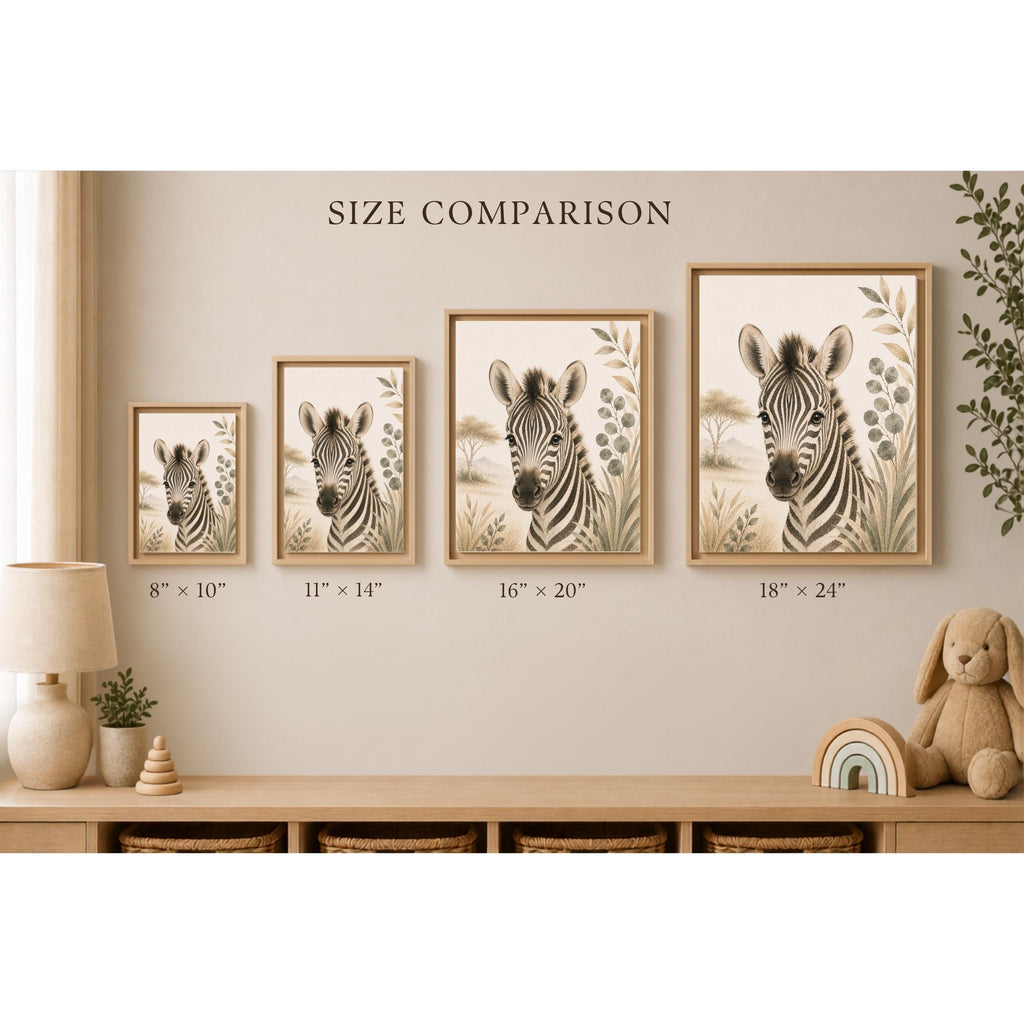 Four framed zebra wall art prints shown in a styled nursery-like room, with size labels beneath each print reading 8" x 10", 11" x 14", 16" x 20", and 18" x 24". The scene includes a lamp, shelf, basket, plant, and stuffed bunny, and the text 'SIZE COMPARISON' appears above the frames.