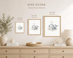 A size guide graphic showing three framed whale canvas prints in different sizes (8 x 10, 11 x 14, and 16 x 20 inches) mounted on a beige wall above a light wood console table with decorative items.