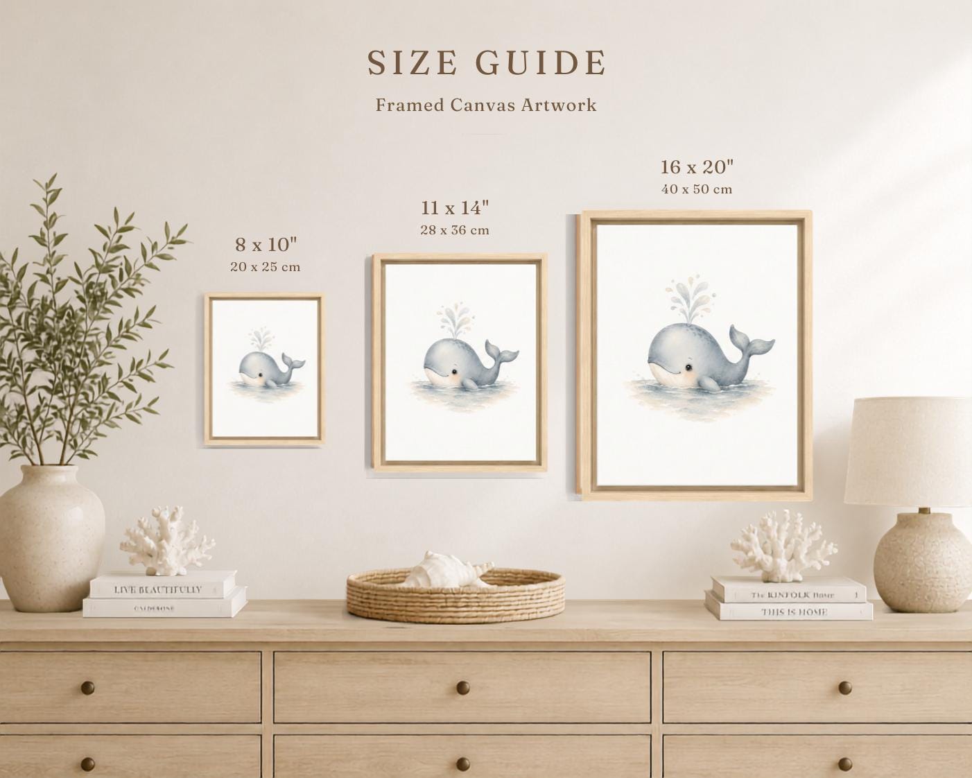 A size guide graphic showing three framed whale canvas prints in different sizes (8 x 10, 11 x 14, and 16 x 20 inches) mounted on a beige wall above a light wood console table with decorative items.