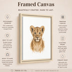 A framed canvas art print featuring a watercolor-style lion cub portrait, shown on a beige background with product feature callouts and the brand name Theo. & Co.