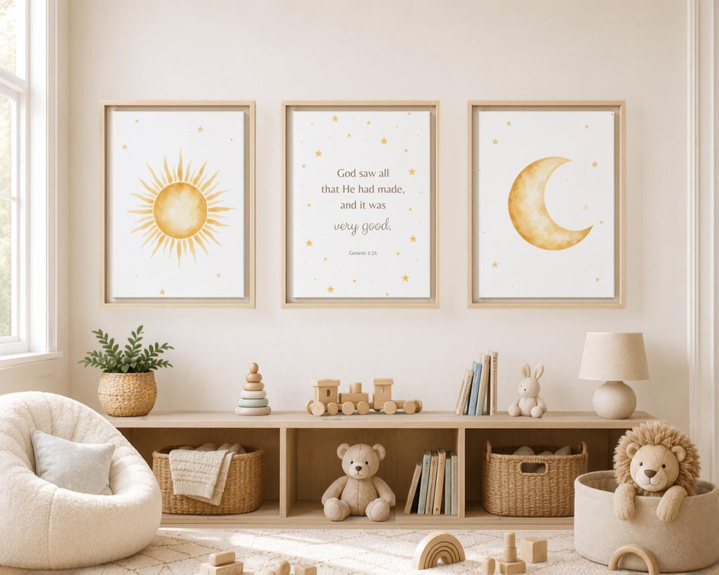 Three framed wall art prints hang above a wooden shelf in a styled nursery. The left print shows a yellow sun, the center shows a Bible verse in black script, and the right print shows a yellow crescent moon with small stars.