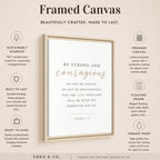 A framed canvas print shown on a warm beige background with marketing text and icons around it. The central product is a vertical white canvas with dark text reading 'BE STRONG and courageous.