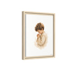 Framed wall art featuring a watercolor-style illustration of a young boy in a beige robe, shown in a light natural wood frame against a white background.
