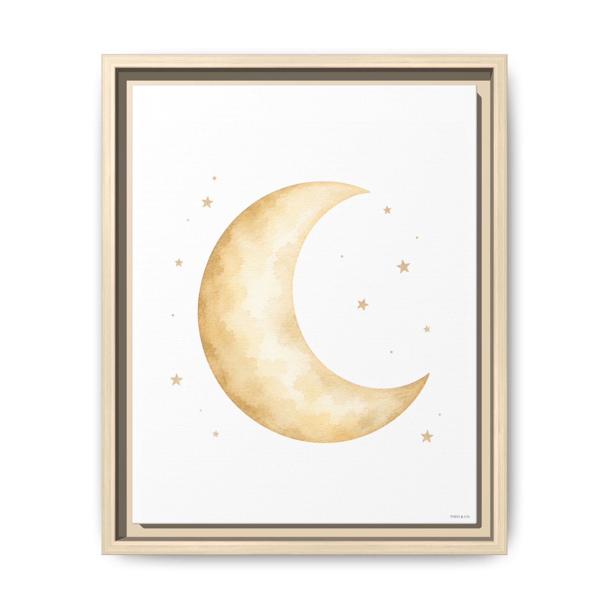 Framed wall art featuring a watercolor-style crescent moon and small stars in warm beige and gold tones on a white background, shown in a light wood frame against a white wall.