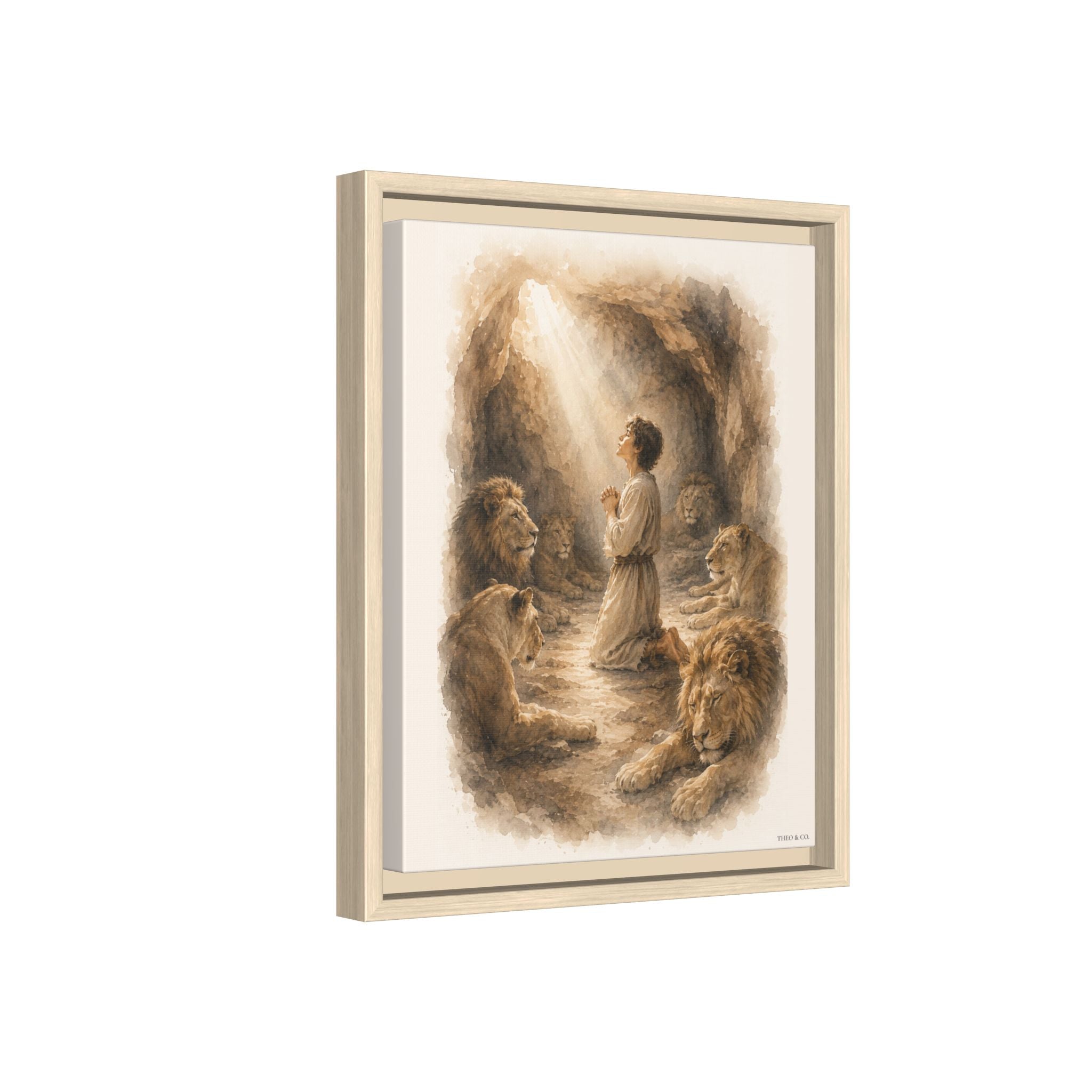 Framed canvas wall art featuring a sepia-toned illustration of a robed figure praying in a cave with lions around him, shown at a slight angle against a white background.