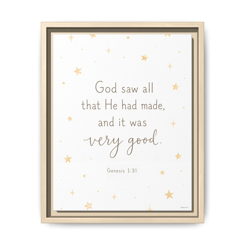 A framed wall art print featuring the Bible verse Genesis 1:31, 'God saw all that He had made, and it was very good.' The text is centered on a white background with scattered small gold stars, and the piece is housed in a light natural wood frame.