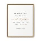 A framed typographic wall art print with the Bible verse Romans 8:28. The print features dark gray text with 'work together' in a rose-gold cursive script, housed in a light beige double-frame design against a clean white background.