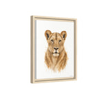 Framed wall art featuring a watercolor-style portrait of a lioness centered on a white background, shown in a light natural wood frame against a plain white backdrop.