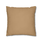 A square throw pillow in a solid tan color, shown against a plain white background with a soft drop shadow.