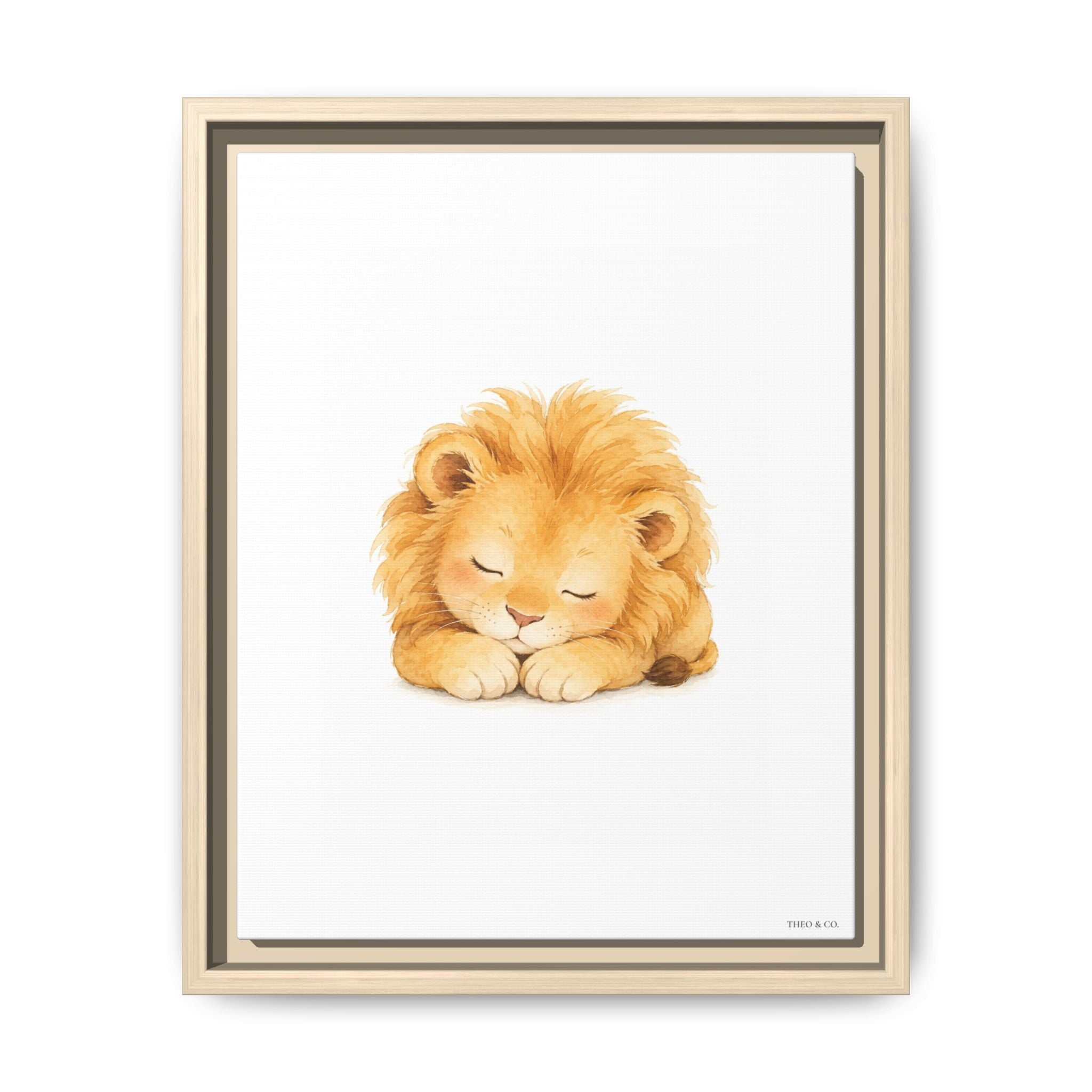 A framed art print featuring a cute watercolor illustration of a sleeping golden lion. The print is housed in a light natural wood frame with a dark inner border, set against a clean white background.