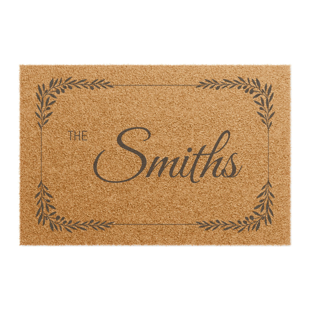 A rectangular natural coir doormat with a dark brown printed border, the words "THE Smiths" in script, and a personalized name design on a white background.
