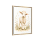 A hung framed floating canvas of a Baby Lamb looking at the viewer in a watercolor green floral field. It is styled on a white background.