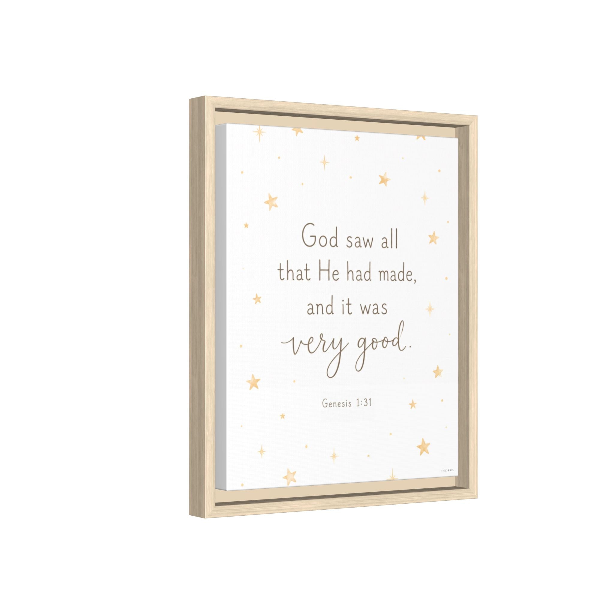 A framed wall art print with a light wood frame, featuring the quote 'God saw all that He had made, and it was very good. Genesis 1:31' in gray text on a white background with scattered small gold stars.
