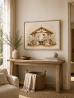 A framed nativity painting hangs on a beige wall above a rustic wooden console table in a warm, neutral-toned living room. The painting depicts Mary, Joseph, baby Jesus, and animals under a thatched stable.