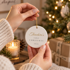 Baby's First Christmas personalized name ornament hanging on a Christmas tree