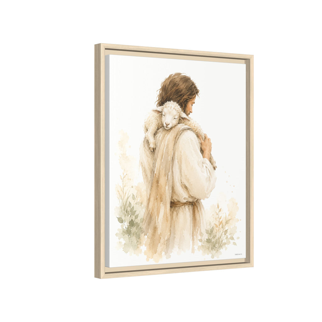 Framed watercolor art print depicting a shepherd carrying a white lamb on his shoulders, shown in a light wood frame against a white background.