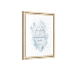 Framed wall art print with a watercolor blue splash and the quote 'YOU ARE fearfully and wonderfully MADE.' on a white background, shown in a light natural wood frame against a white backdrop.