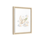 Framed wall art featuring a white dove in flight holding a green olive branch, surrounded by soft pastel clouds, shown in a light natural wood frame against a white background.