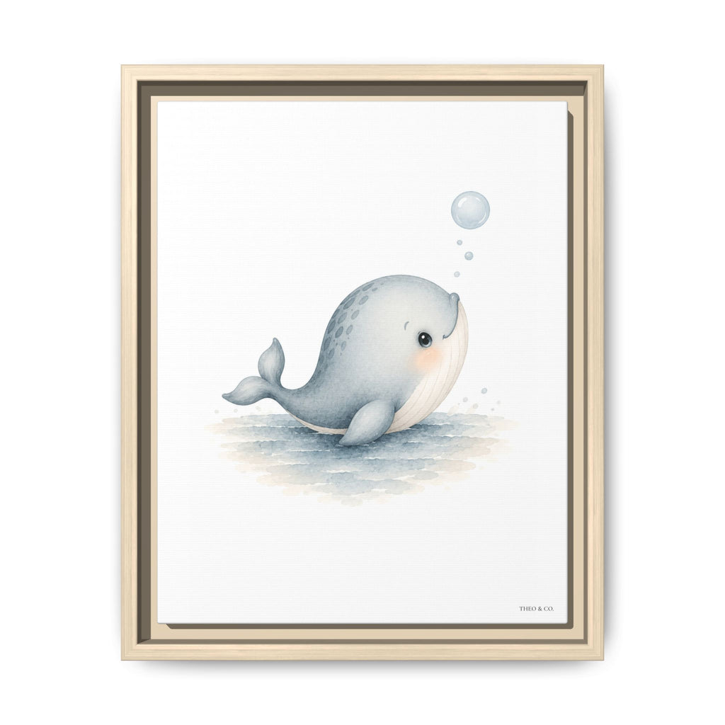 A framed art print featuring a cute, stylized illustration of a light blue-gray beluga whale blowing bubbles on a white background, housed in a light wood frame.