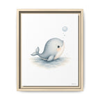 A framed art print featuring a cute, stylized illustration of a light blue-gray beluga whale blowing bubbles on a white background, housed in a light wood frame.