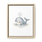 A framed watercolor art print featuring a cute gray baby whale swimming in light blue water with a small splash, set in a light beige double-frame against a white background.