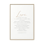 A framed typographic wall art print featuring the word 'Love' in large cursive at the top and a centered Bible verse from 1 Corinthians 13:4-7 in small serif text below, shown in a thin light wood frame against a white background.