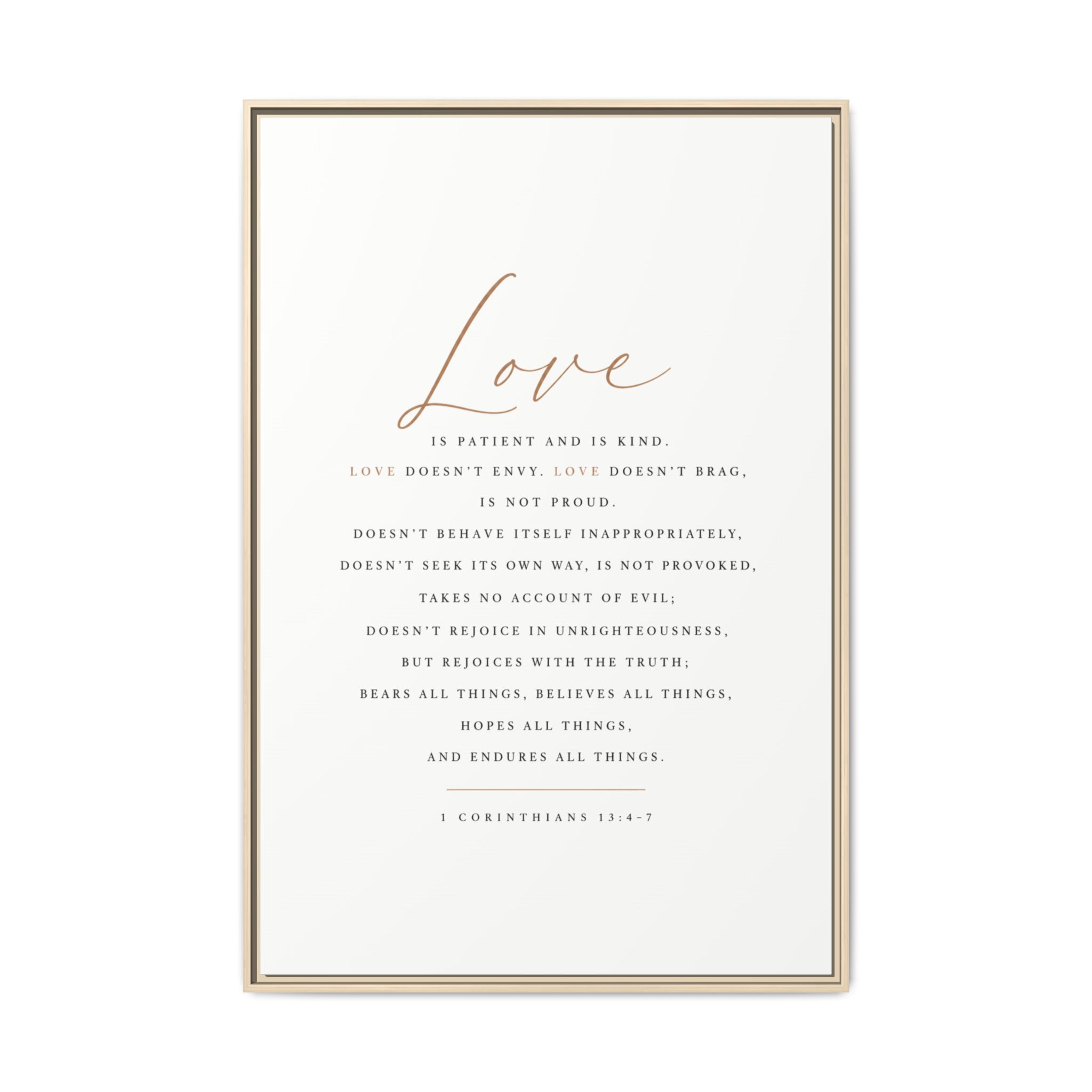 A framed typographic wall art print featuring the word 'Love' in large cursive at the top and a centered Bible verse from 1 Corinthians 13:4-7 in small serif text below, shown in a thin light wood frame against a white background.