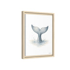 Framed wall art featuring a watercolor-style illustration of a gray mermaid tail rising from light blue water on a white background, shown in a light natural wood frame against a white backdrop.