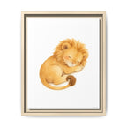 Framed wall art featuring a watercolor illustration of a sleeping lion cub in warm golden and tan tones on a white background, shown in a light wood frame against a white wall.